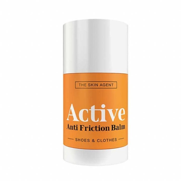 The Skin Agent Active Anti Friction Balm stift motvirker gnagsår fra klær og sko i hvit og oransje hylse
