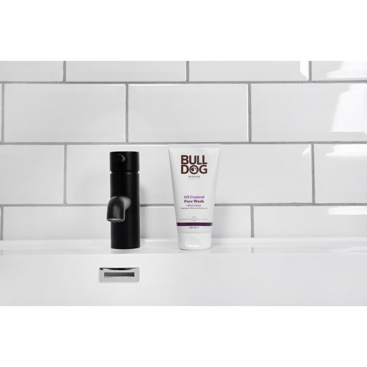 Bulldog Oil Control Face Wash 150 ml ansiktsrens som fjerner overflødig olje står ved en sort kran på et baderom