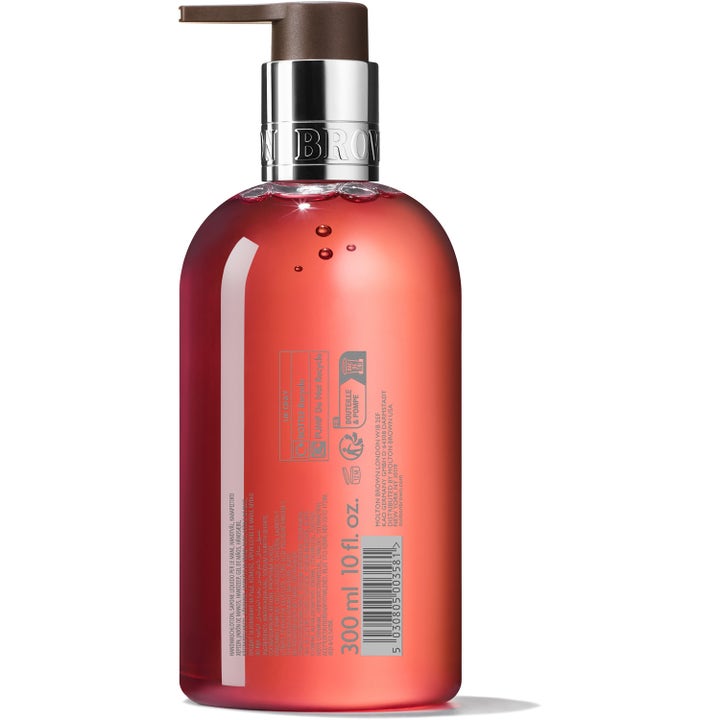 Molton Brown Heavenly Gingerlily 300 ml håndsåpe i gjennomsiktig flaske med rosa såpe sett fra baksiden.