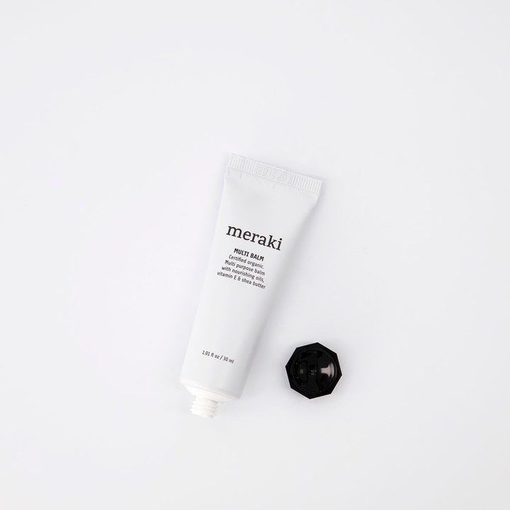 Meraki Multi balm 30 ml nærende ansiktskrem med vitamin E og sheasmør i hvit tube med avskrudd sort lokk