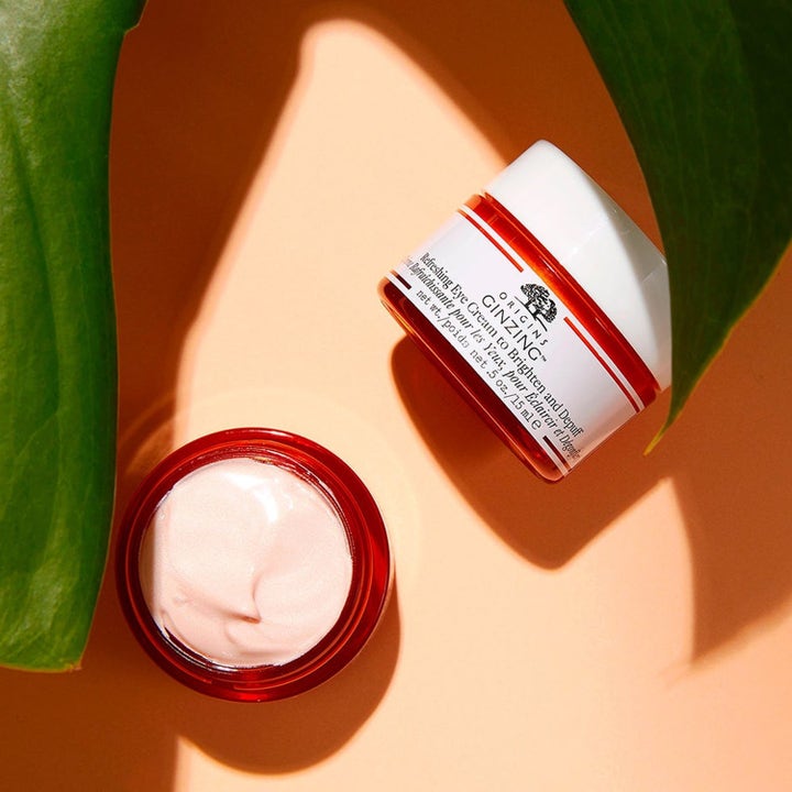 Origins Eye Reviver 30 ml oppfriskende øyekrem i oransje krukke som viser en glinsende ferskenfarget krem.