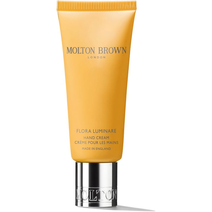 Molton Brown Flora Luminare Hand Cream 40ml pleiende håndkrem i en solgul tube med preget sølvfarget kork.