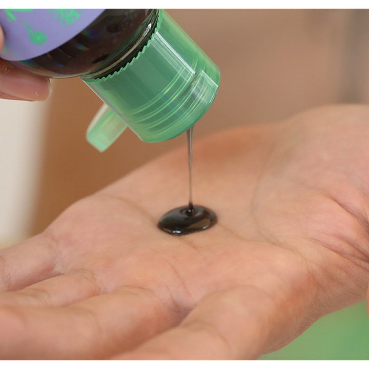 Chasin' Rabbits Mindful Bubble Cleanse 200 ml ansiktsrens helles som en mørk gelé fra grønn flaske i en hånd.