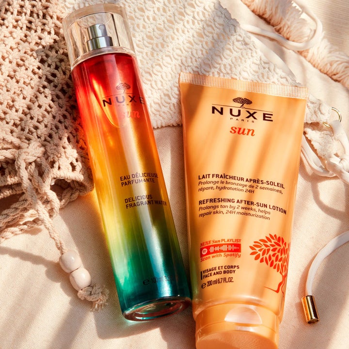 Nuxe Sun Kit med 100 ml duftspray og 200 ml aftersun lotion som pleier huden på en lys strikket strandveske