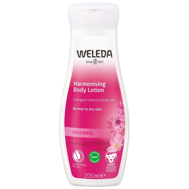 Weleda Harmonising Body Lotion 200 ml fuktighetsgivende kroppslotion i hvit plastflaske med dekorative rosa villroser