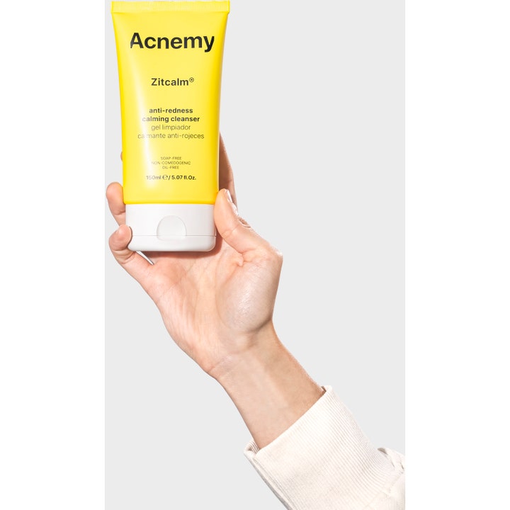 Niche Beauty Lab Acnemy Zitcalm Cleansing Gel 150 ml beroligende ansiktsrens mot rødhet i gul tube holdt av en hånd.