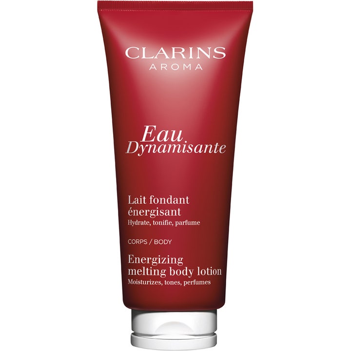 Clarins Eau Dynamisante 200 ml energigivende bodylotion i rød tube med hvitt skrulokk gir fukt og glød.