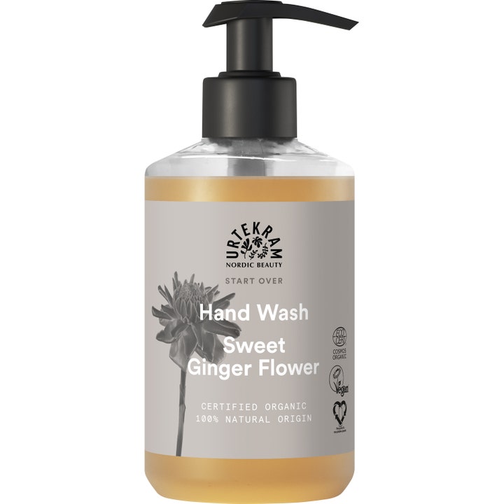 Urtekram Sweet Ginger Flower Hand Wash pleiende vegansk håndsåpe i gjennomsiktig pumpeflaske med gyllen væske.