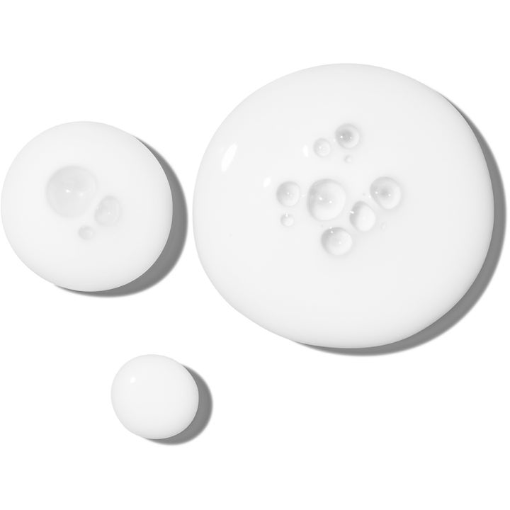 The Ordinary Rice Lipids + Ectoin Microemulsion 120 ml dagkrem viser en hvit flytende tekstur med små luftbobler.