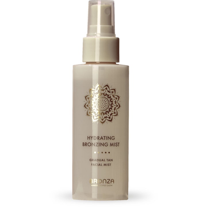 Bronza Hydrating Bronzing Mist fuktighetsgivende selvbruning i beige sprayflaske med mandala og gulldetaljer