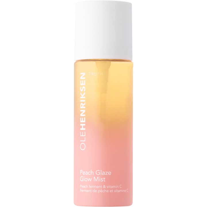 Olehenriksen Peach Glaze Glow Mist ansiktsspray med vitamin C gir glød i ferskenfarget gradientflaske med hvit kork