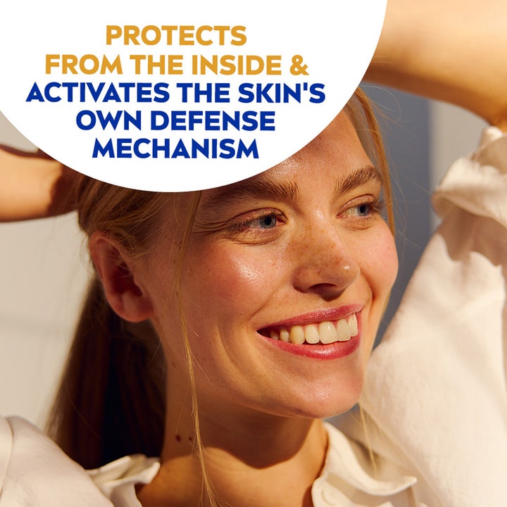 NIVEA UV Face Triple Protect Fluid SPF50+ 40 ml solkrem som aktiverer hudens forsvar vist på en smilende kvinne