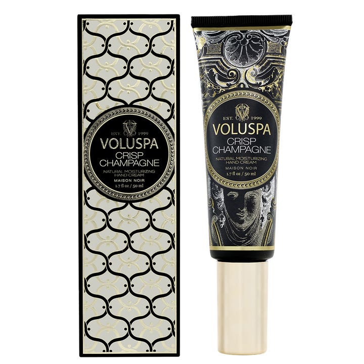 Voluspa Crisp Champagne 50 ml fuktighetsgivende håndkrem i tube med dekorativ eske i sort og gull.