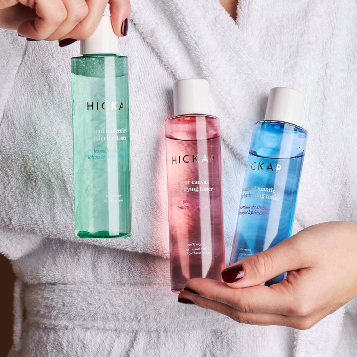 Hickap Mermaid Mantle Deep Hydrating Toner 150 ml fuktgivende ansiktsvann i blå flaske holdt av person i hvit badekåpe