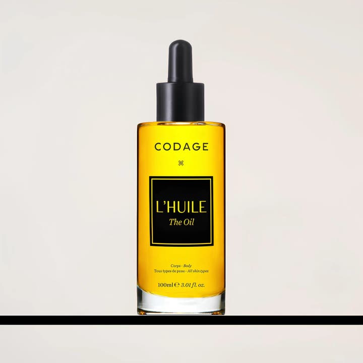 Codage Paris The Oil 100 ml nærende kroppsolje i klar glassflaske med gyllen olje og svart pipette