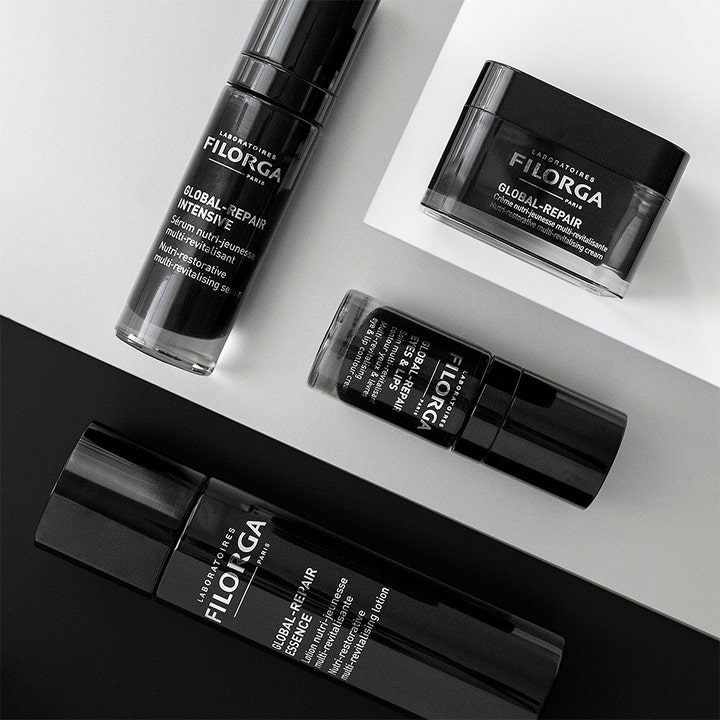 Filorga Global-Repair Essence 150 ml ansiktsvatten i svart flaske med andre produkter i serien