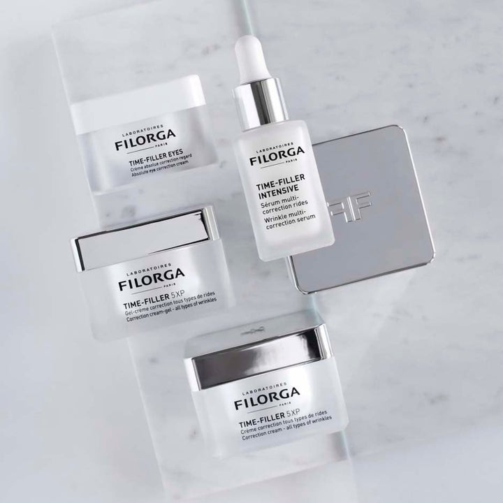 Filorga Anti-Wrinkle Set rynkekorrigerende hudpleie i hvite krukker og serumflaske med sølvdetaljer