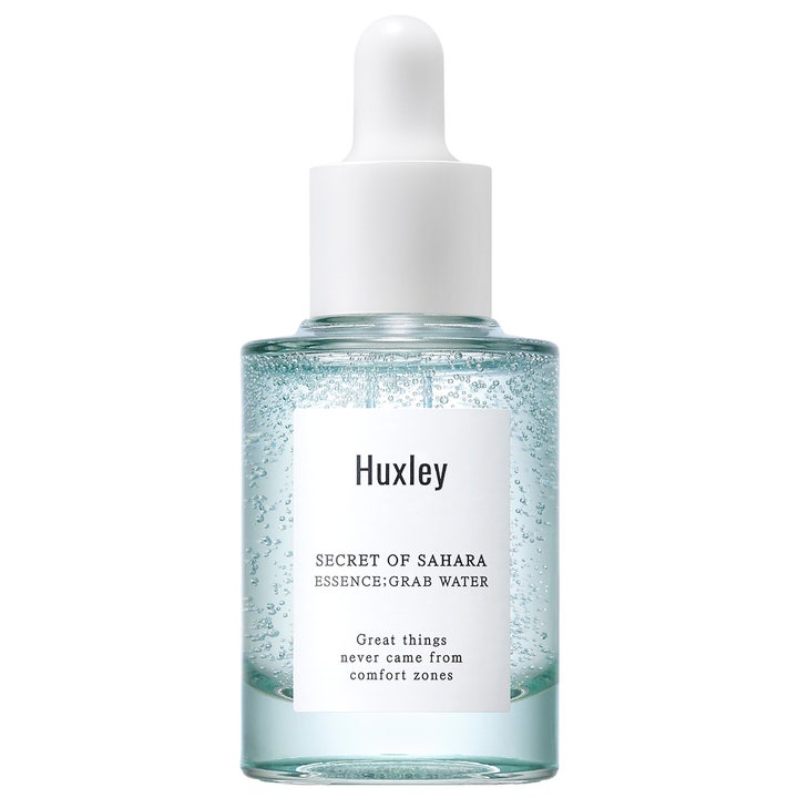 Huxley Secret of Sahara Essence Grab Water 30ml fuktgivende essens i glassflaske med hvit pipette og synlige bobler
