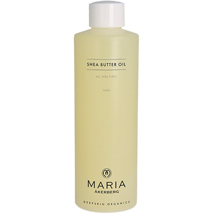 Maria Åkerberg Shea Butter Oil mykgjørende kroppsolje i en frostet plastflaske med hvit kork og lys gul olje.