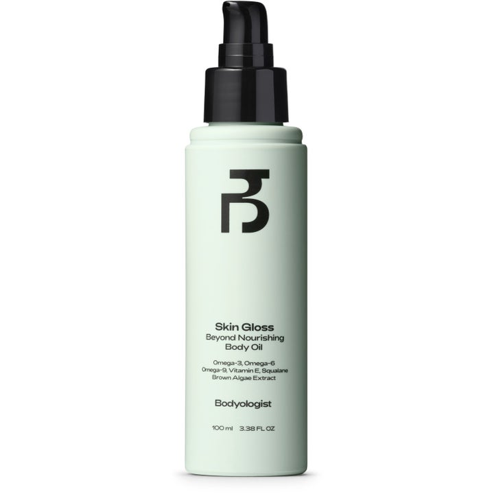 Bodyologist Skin Gloss 100 ml nærende kroppsolje med squalane i lys grønn flaske med svart pumpe for sunn glød