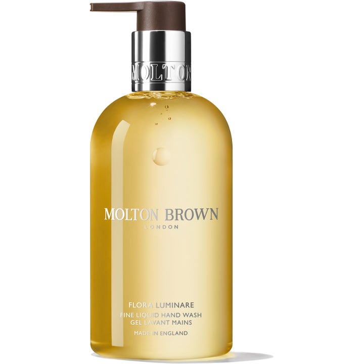 Molton Brown Flora Luminare Hand Wash 300 ml rengjørende håndsåpe med gyllen gelé i klar flaske med sølvfarget pumpe