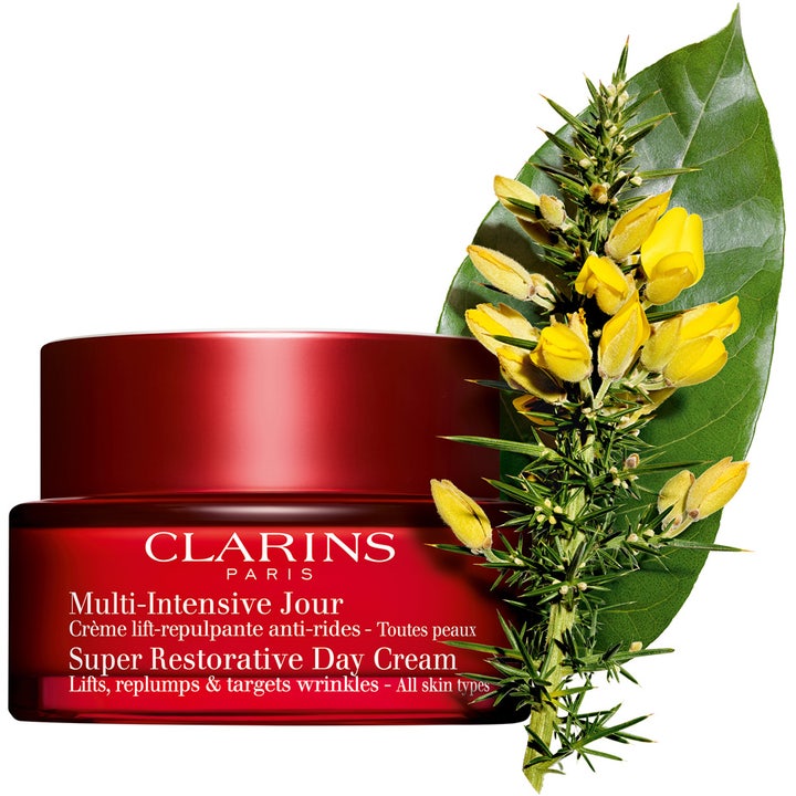 Clarins Super Restorative Day Cream 50 ml oppstrammende dagkrem i rød krukke med gule blomster og et grønt blad