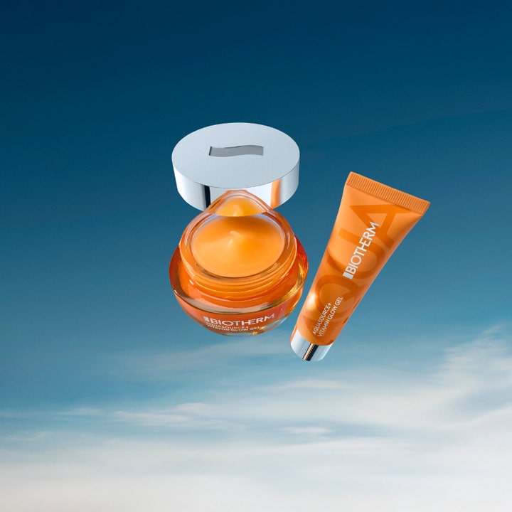 Biotherm Aquasource Vitamin Glow Gel 30 ml glødgivende dagkrem i oransje krukke og tube mot blå himmel