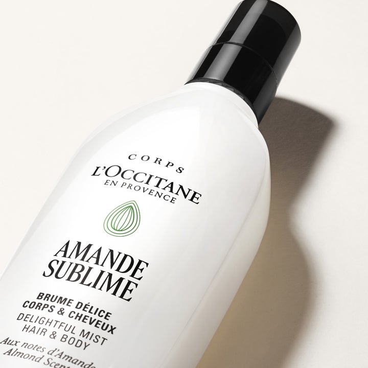 L'Occitane en Provence Almond Hair Body Mist 100 ml velduftende mist i hvit flaske med sort kork og mandel-ikon