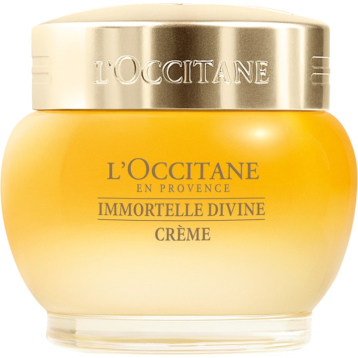 L'Occitane Immortelle Divine Crème anti-aging ansiktskrem i en rund gul glasskrukke med skinnende gullokk.