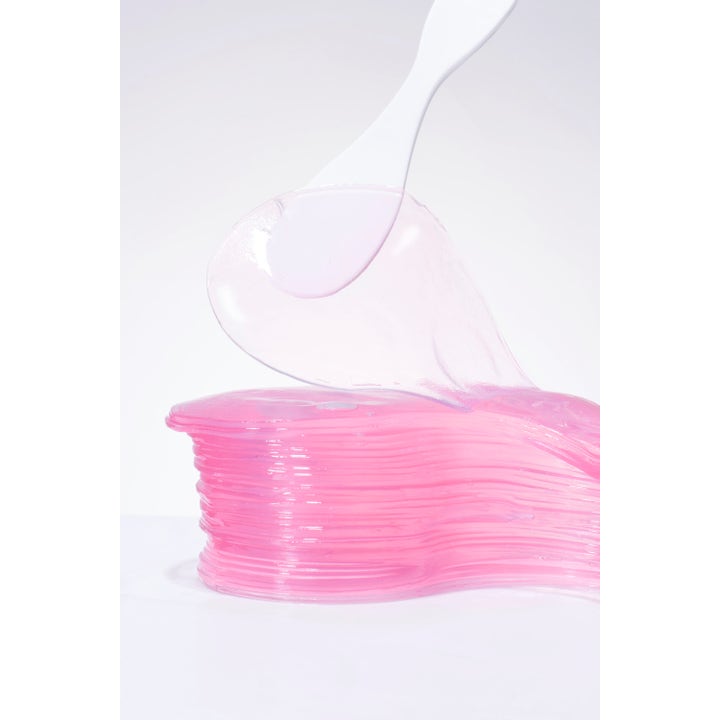 COSRX The Peptide Collagen Hydrogel Eye patch 60 stk fuktighetsgivende rosa hydrogel-patcher og hvit spatel.