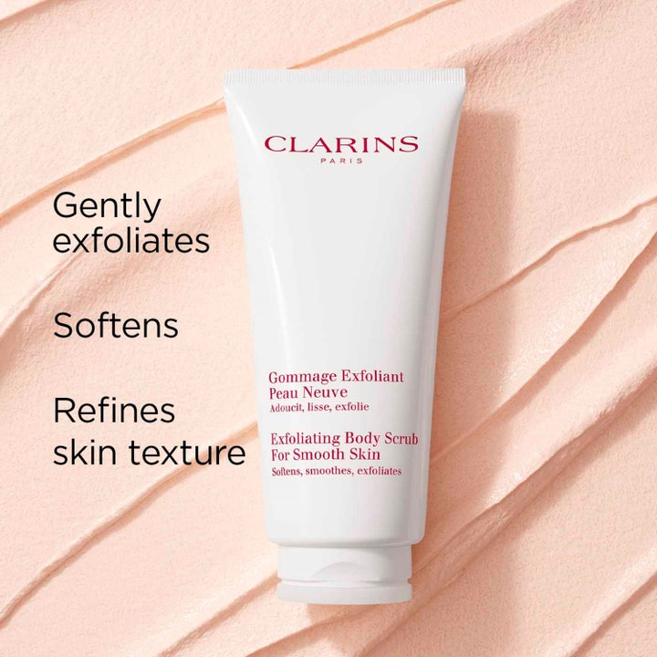 Clarins Exfoliating Body Scrub 200 ml på en bakgrunn av kremet lyserosa tekstur som gir myk hud.