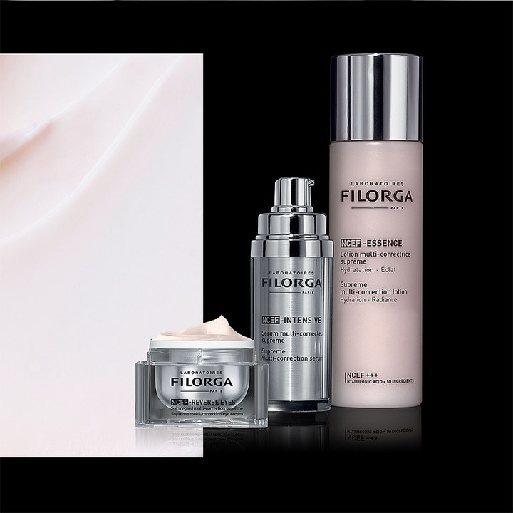 Filorga NCEF-Reverse Eyes 15 ml multi-korrigerende øyekrem i åpen krukke med lyserosa tekstur ved siden av serum
