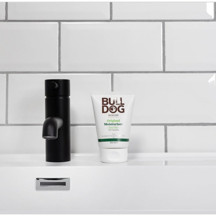 Bulldog Original Moisturiser 100 ml fuktighetsgivende ansiktskrem i hvit tube ved en sort kran på et baderom