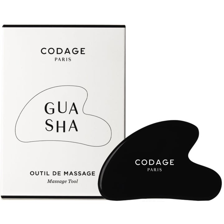 Codage Paris Gua Sha massasjeverktøy for ansiktet i sort sten ved siden av hvit ytteremballasje.