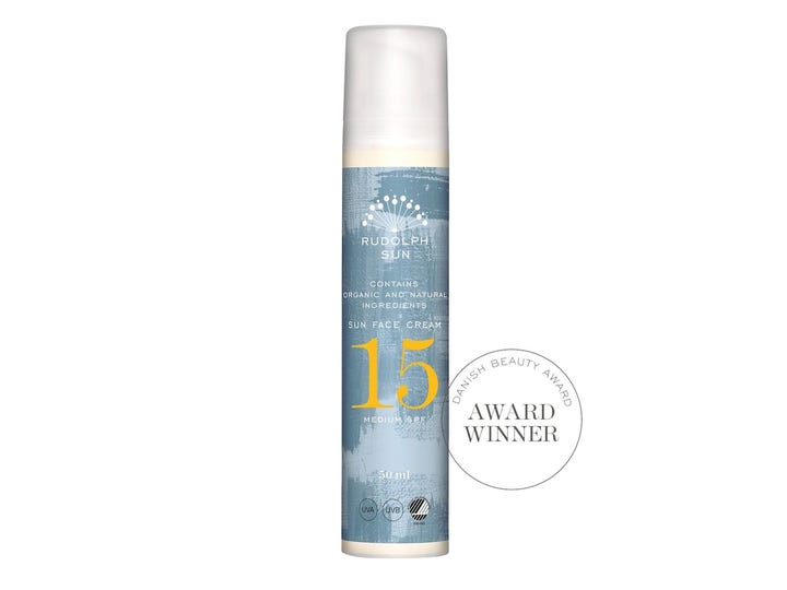 Rudolph Care Sun Face Cream SPF 15 50 ml i sylindret pumpeflaske med blått design og hvit kork for solbeskyttelse.