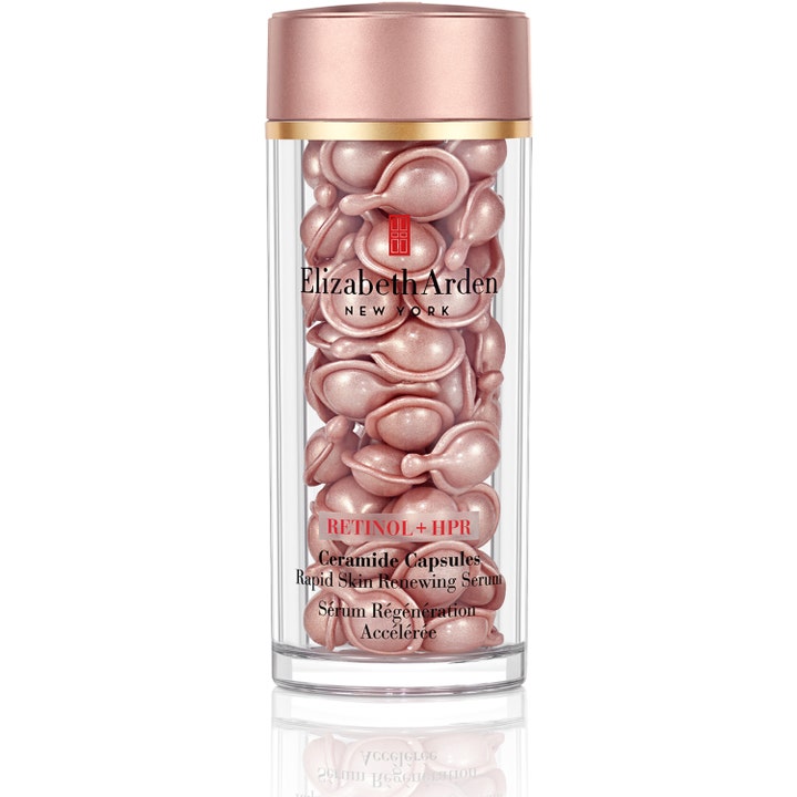 Elizabeth Arden Retinol + HPR Ceramide Capsules fornyende serum i klar beholder med rosa kapsler og rosegullokk.