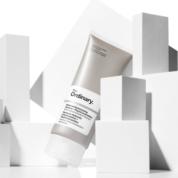 The Ordinary Natural Moisturizing Factors + Phytoceramides 30 ml fuktighetskrem i beige tube plassert blant hvite blokker.